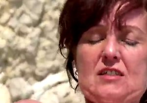 Older lady getting fucked on a rocky beach